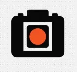 Pictogramme de caméra tel que généré : boîtier noir, cadre blanc et objectif orange.